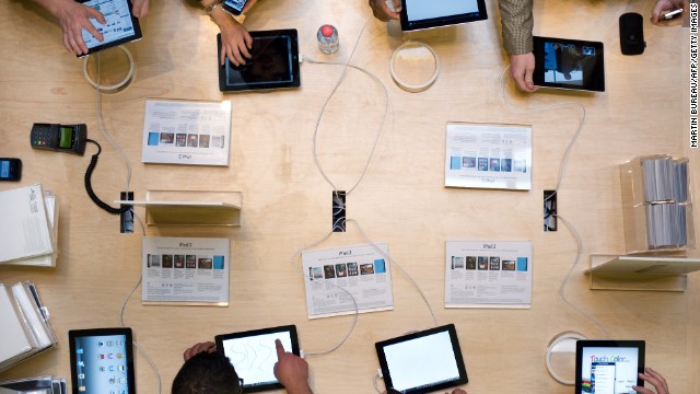 Customers play with iPad 2s during a Apple store in Paris's ancestral Opera district on Mar 25, 2011, a day a device went on sale in 25 countries. The second era of a inscription combined dual cameras.