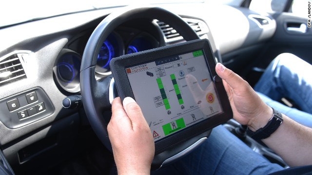 Driving instructor Horst Heider uses an iPad during a safety-training category for seniors in Boksee, Germany, on Jun 20, 2013.