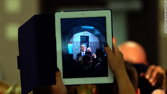 A tyro uses her iPad to take a pattern of President Barack Obama as he greets students during a center propagandize in Mooresville, North Carolina, on Jun 6, 2013. 